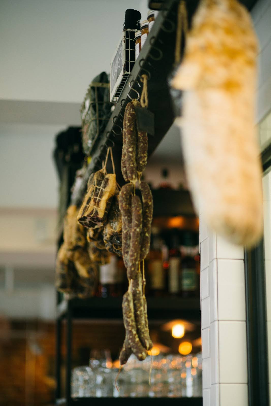 House-made charcuterie and sausages hanging at Main Street Meats, the best butcher near me in Chattanooga.